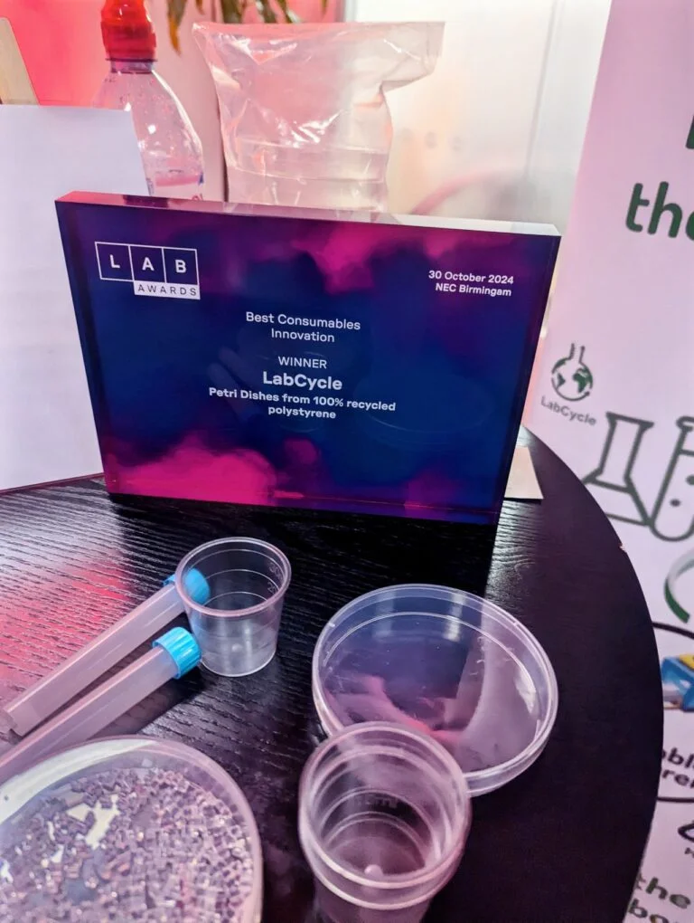 The Lab Awards Best Consumables Innovation winner plaque beside LabCycle petri dishes and tubes made from recycled polystyrene
